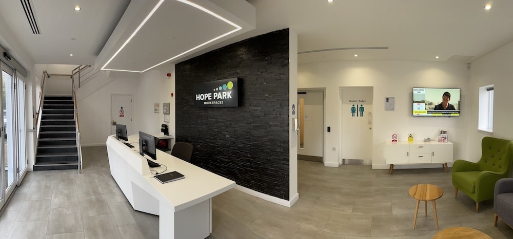 Reception desk and Hope Park Workspaces sign at Quays Reach, Salford