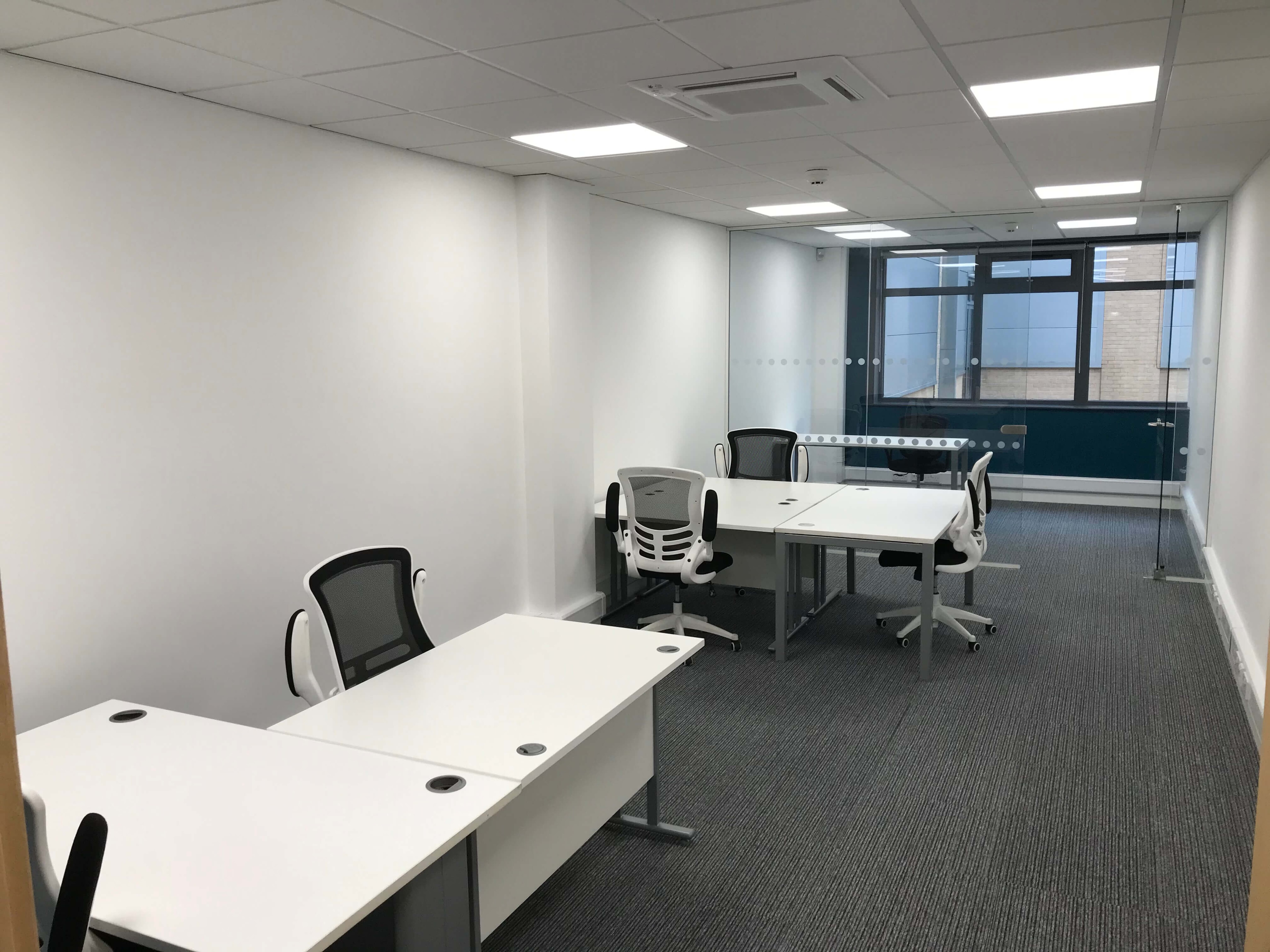 Empty office with desks and office chairs ready to move into