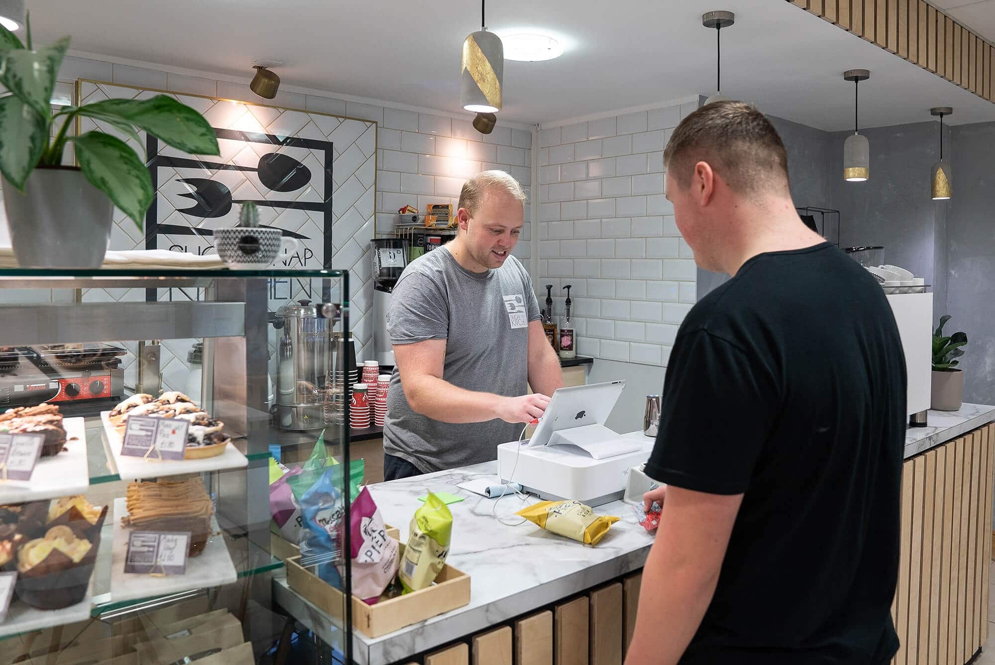 Customer being served at the Sugar Snap Kitchen café counter at Hope Park
