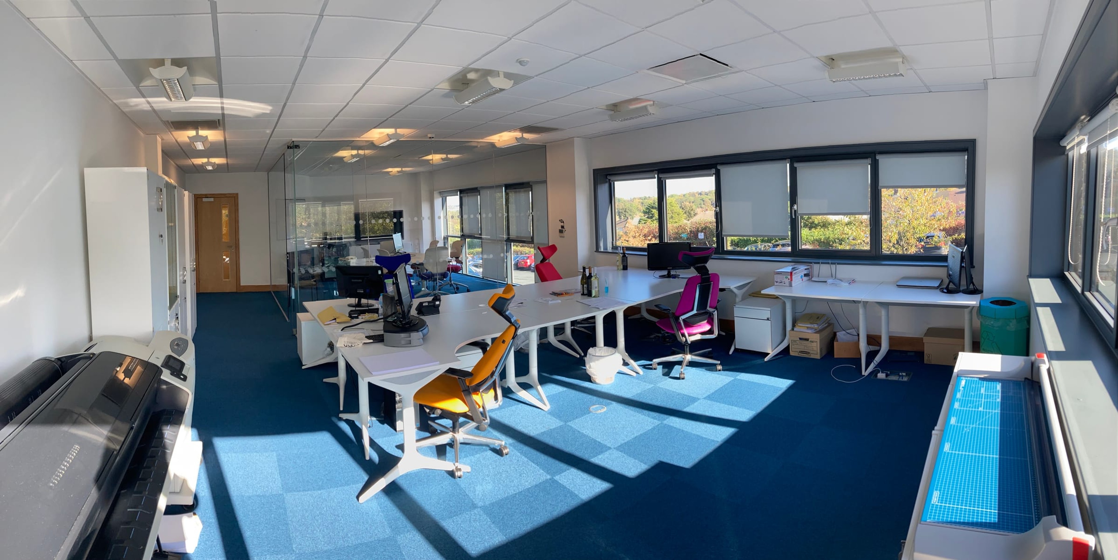 Open-plan desk area with large windows and blue carpet in the 10-15 person office at Hope Park City Gateway, Bradford