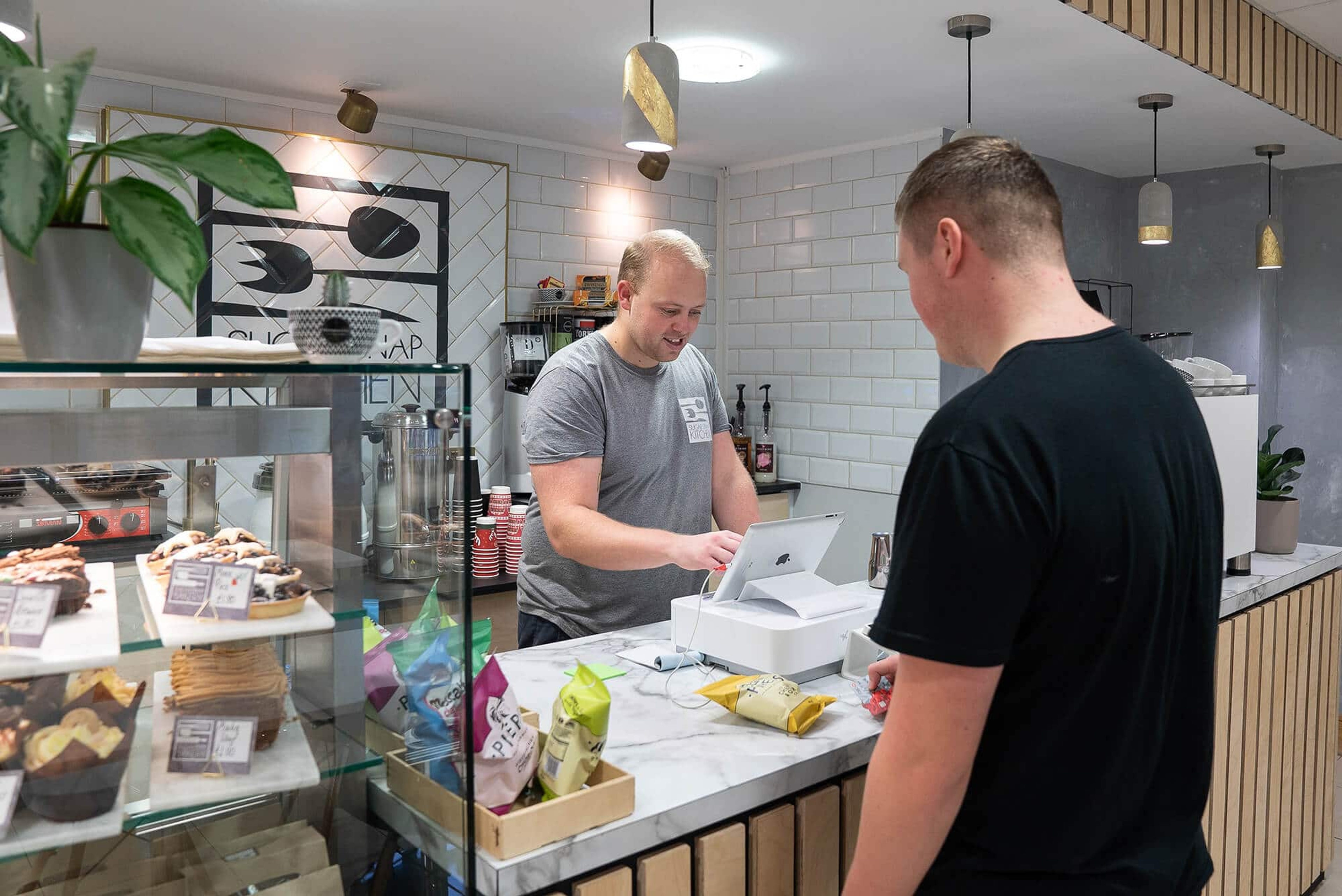 Man ordering crisps in the kitchen