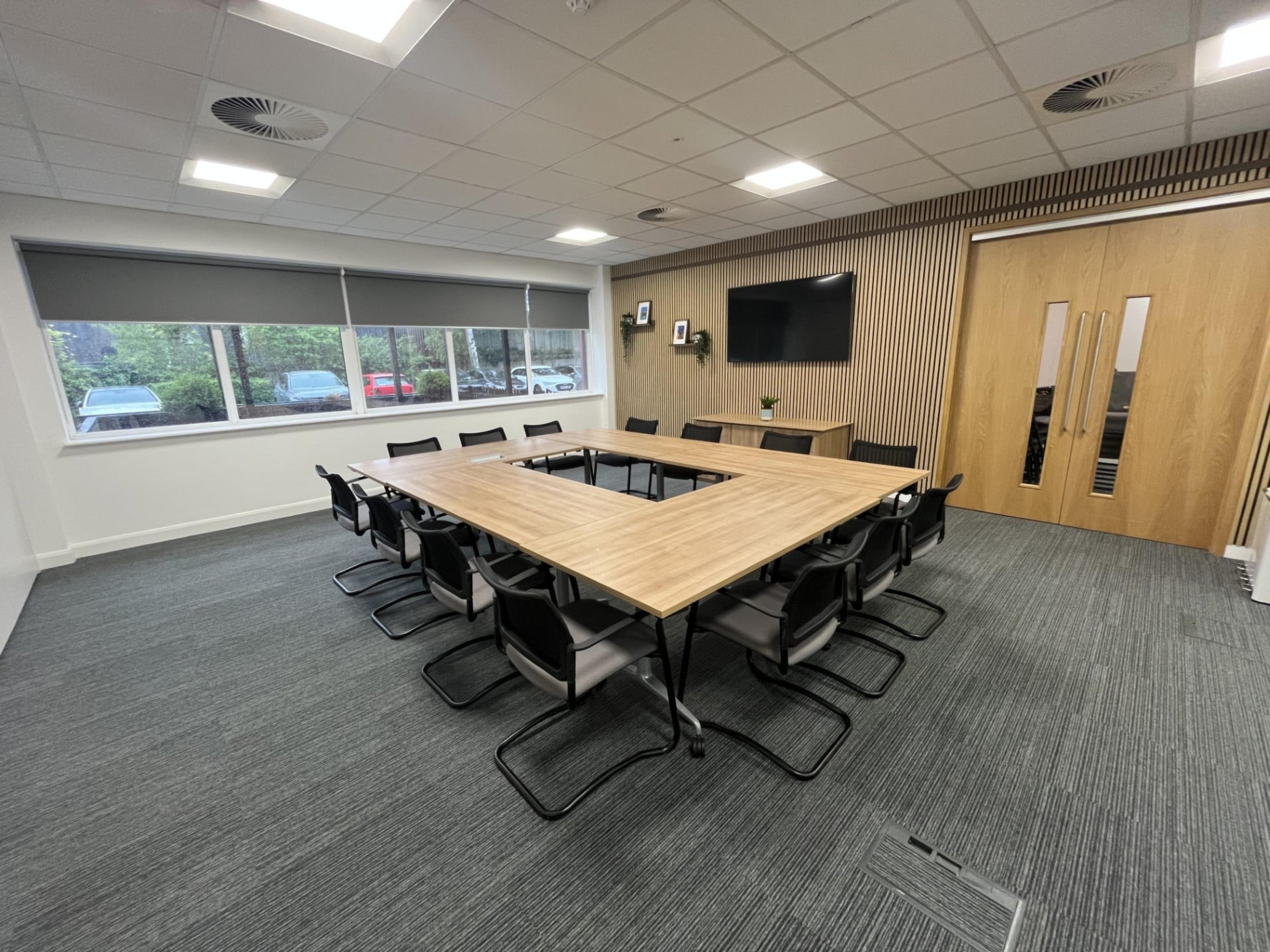 The Boardroom at Hope Park Quays Reach Salford with a long boardroom table and Salford Quays views