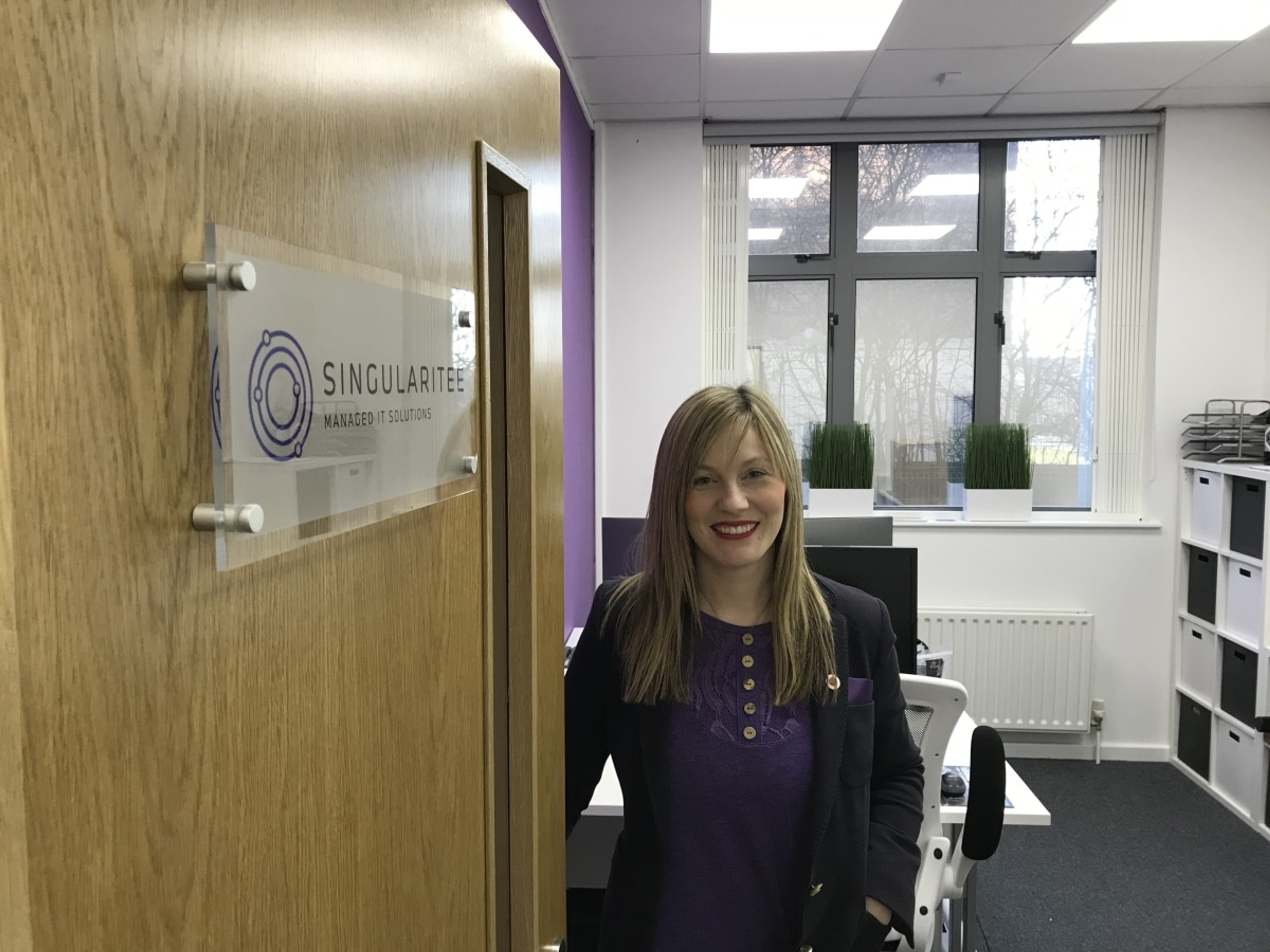 Smiling Employee Opening The Door Into The Office
