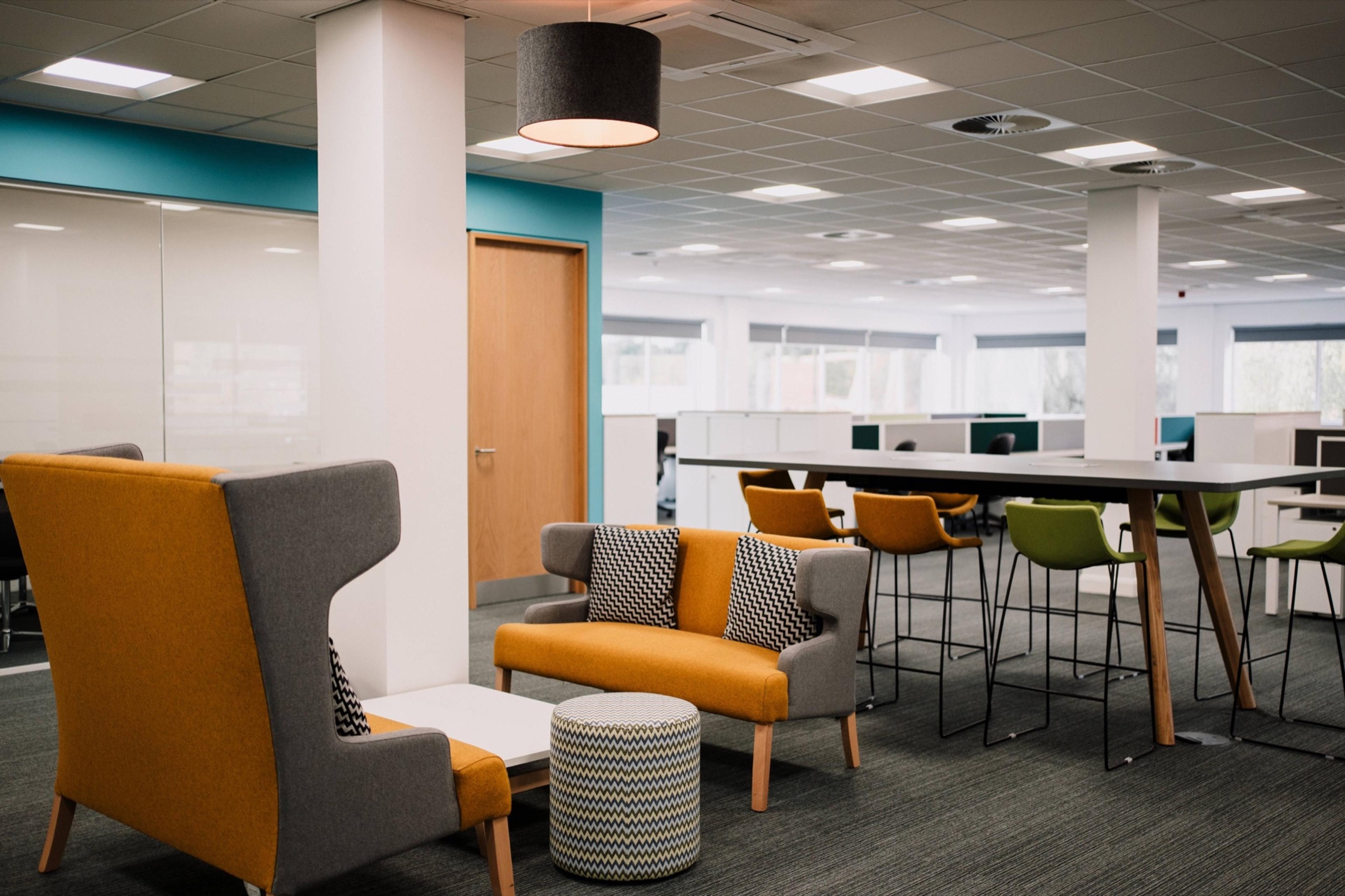 Breakout area with armchairs and high tables at Hope Park Quays Reach, Salford