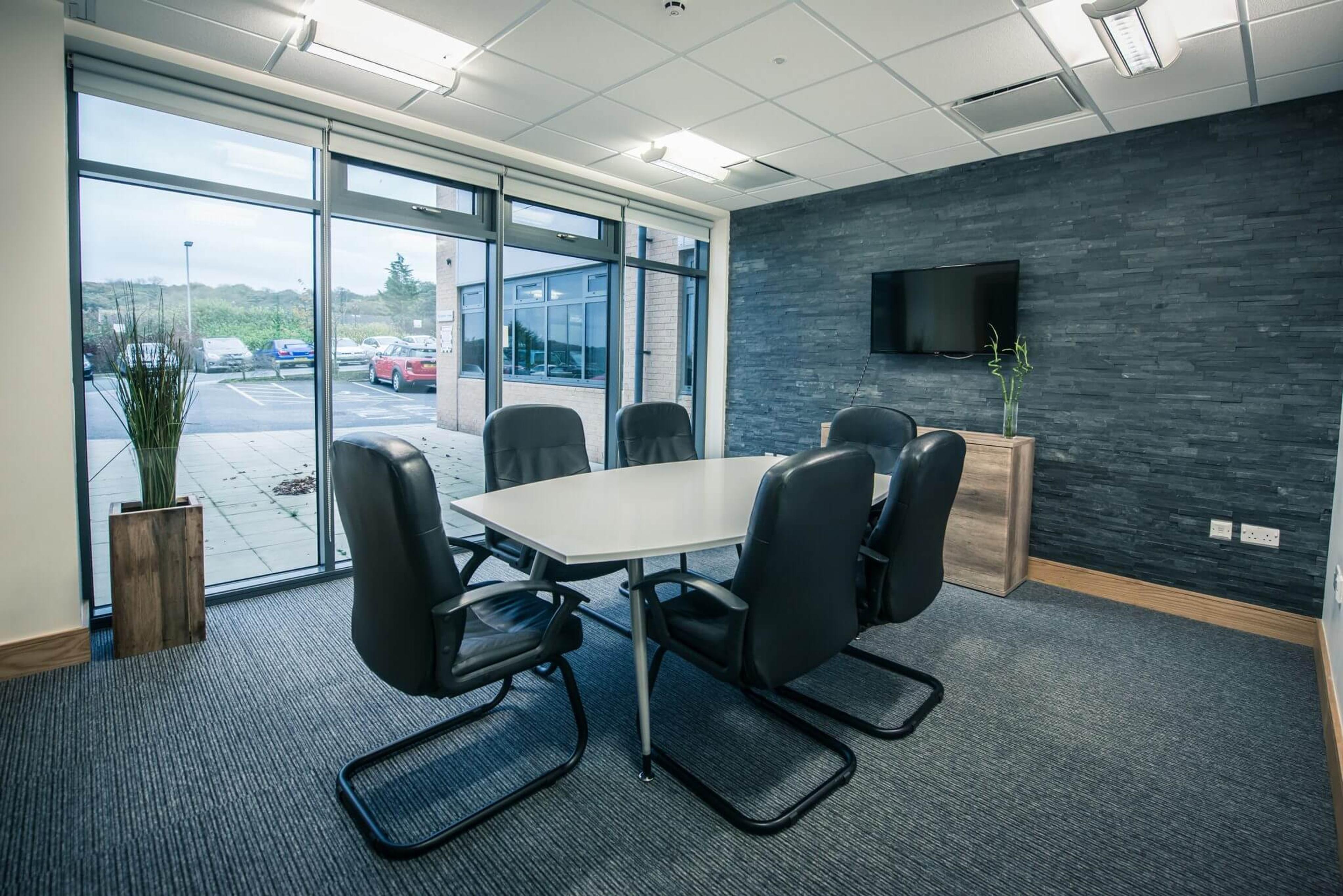 The Wood meeting room at City Gateway Bradford with a boardroom-style table and screen