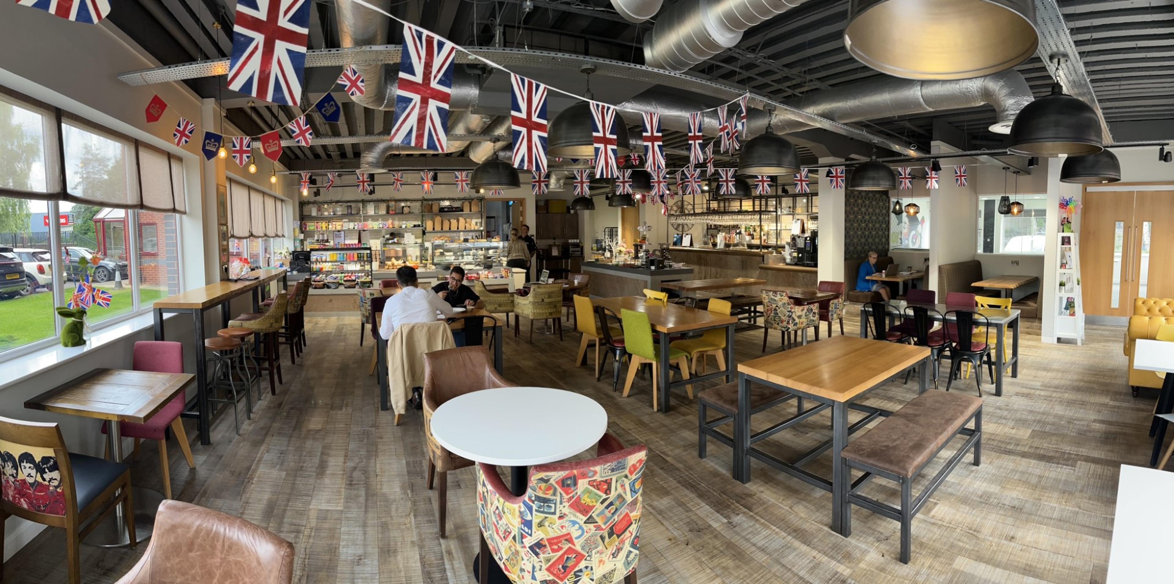 The café at Quays Reach, Salford, with wooden tables and bar seating